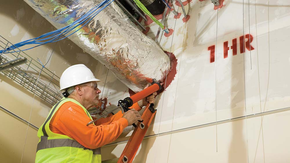 Mechanical Insulators LMCT | Firestop And Smokeseal | LMCT-Affiliated Contractor Applying Firestopping Caulk