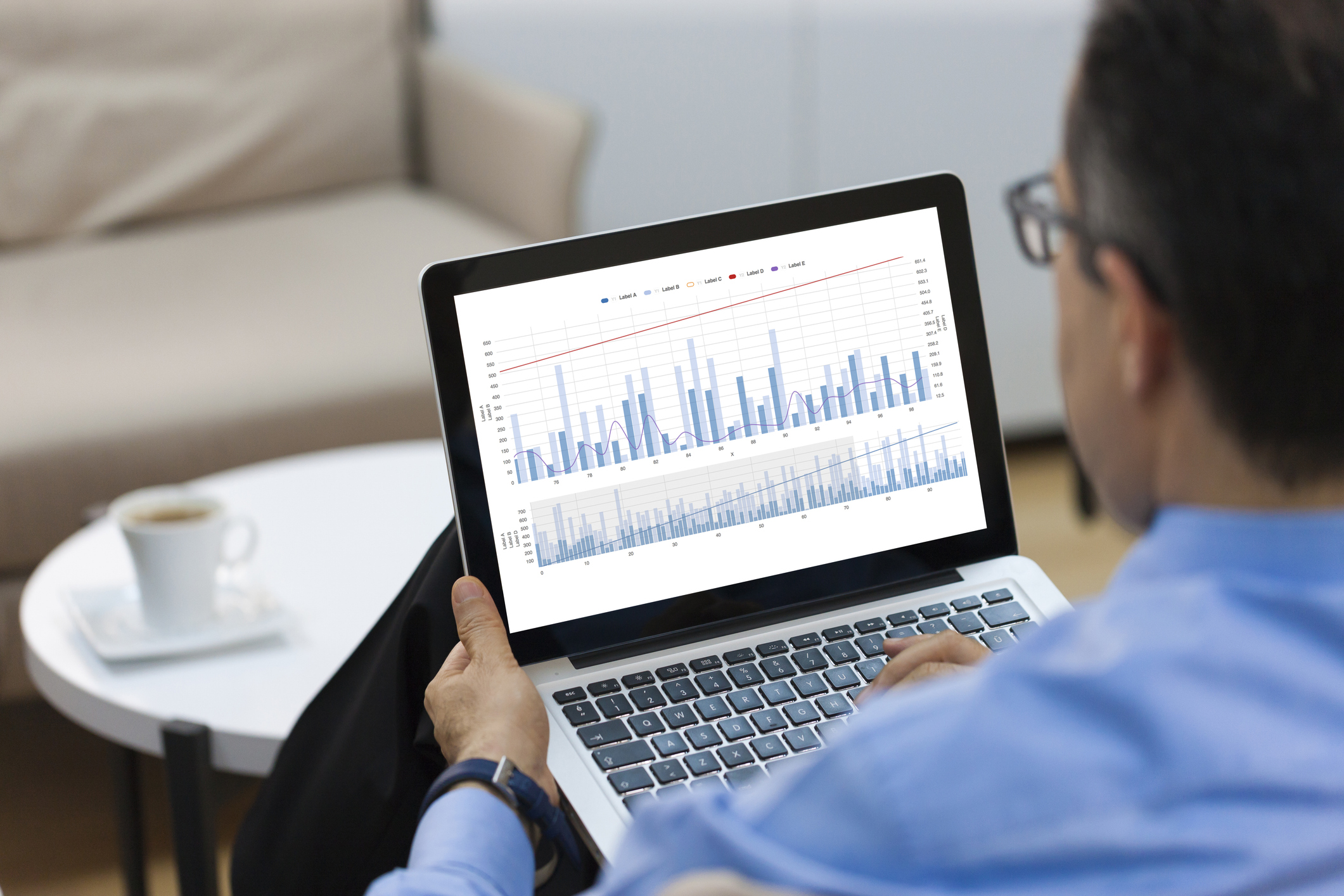 Businessman looking Financial Charts on laptop Experience Modification Rate | Contractor Looking At EMR Data | Insulators LMCT